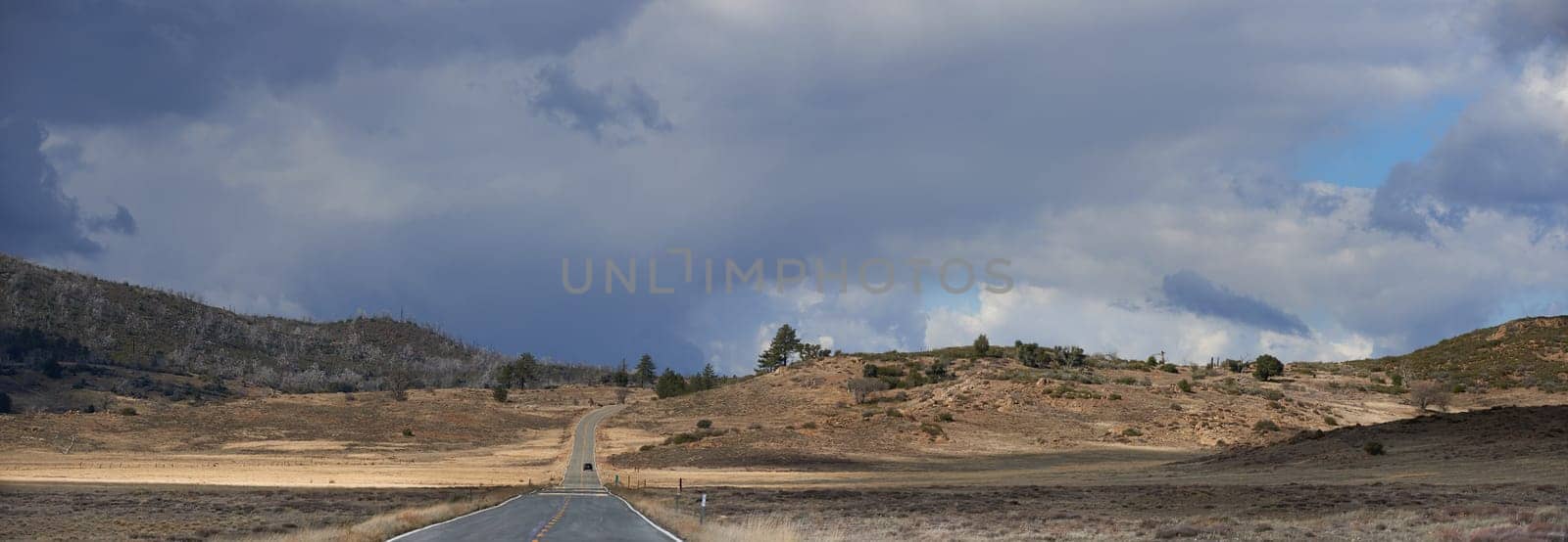 Landscape, countryside and road in desert with nature for banner, drive and travel on holiday in Arizona. Outdoor, adventure and tourism with sustainability, camping and vacation to relax or chill.