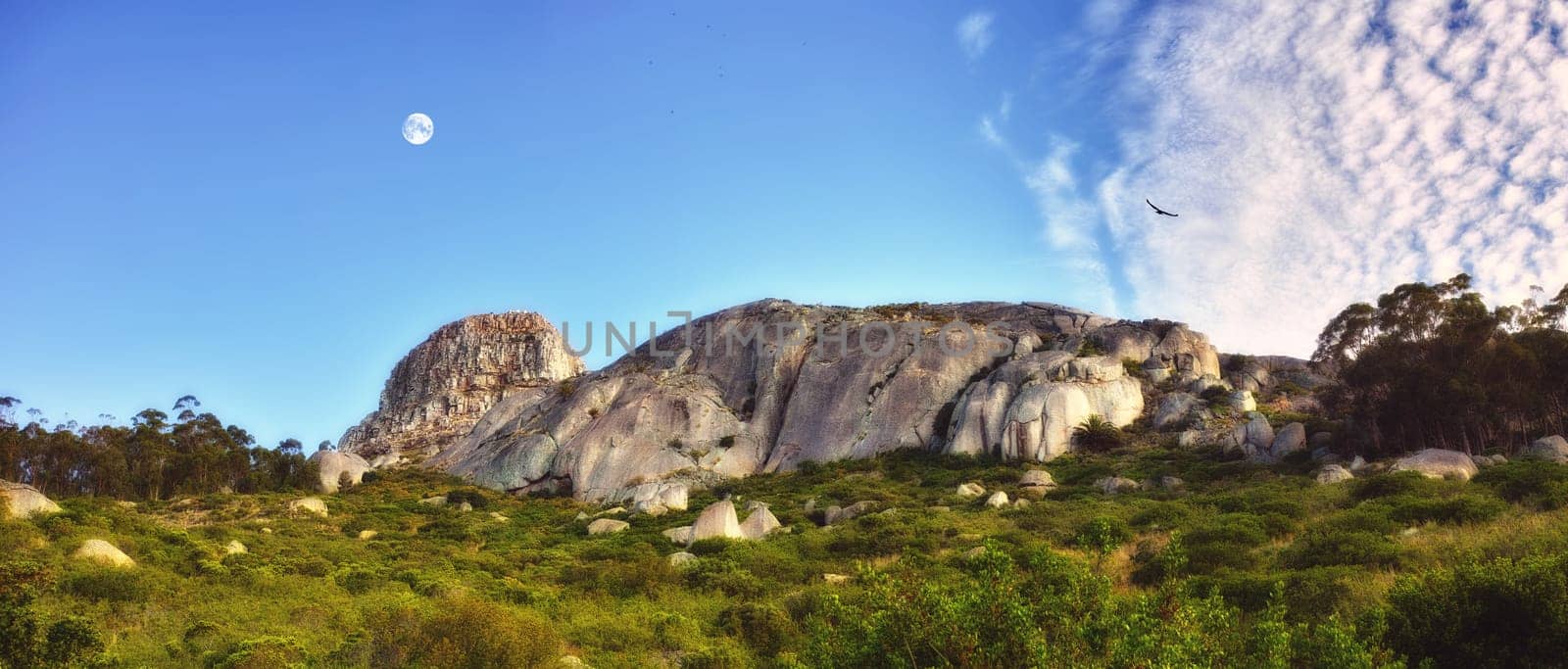 Nature, mountains and green grass with rock formation for travel destination on holiday in Cappadocia, Turkey. Natural landscape, sustainable environment and ecosystem in countryside for vacation.