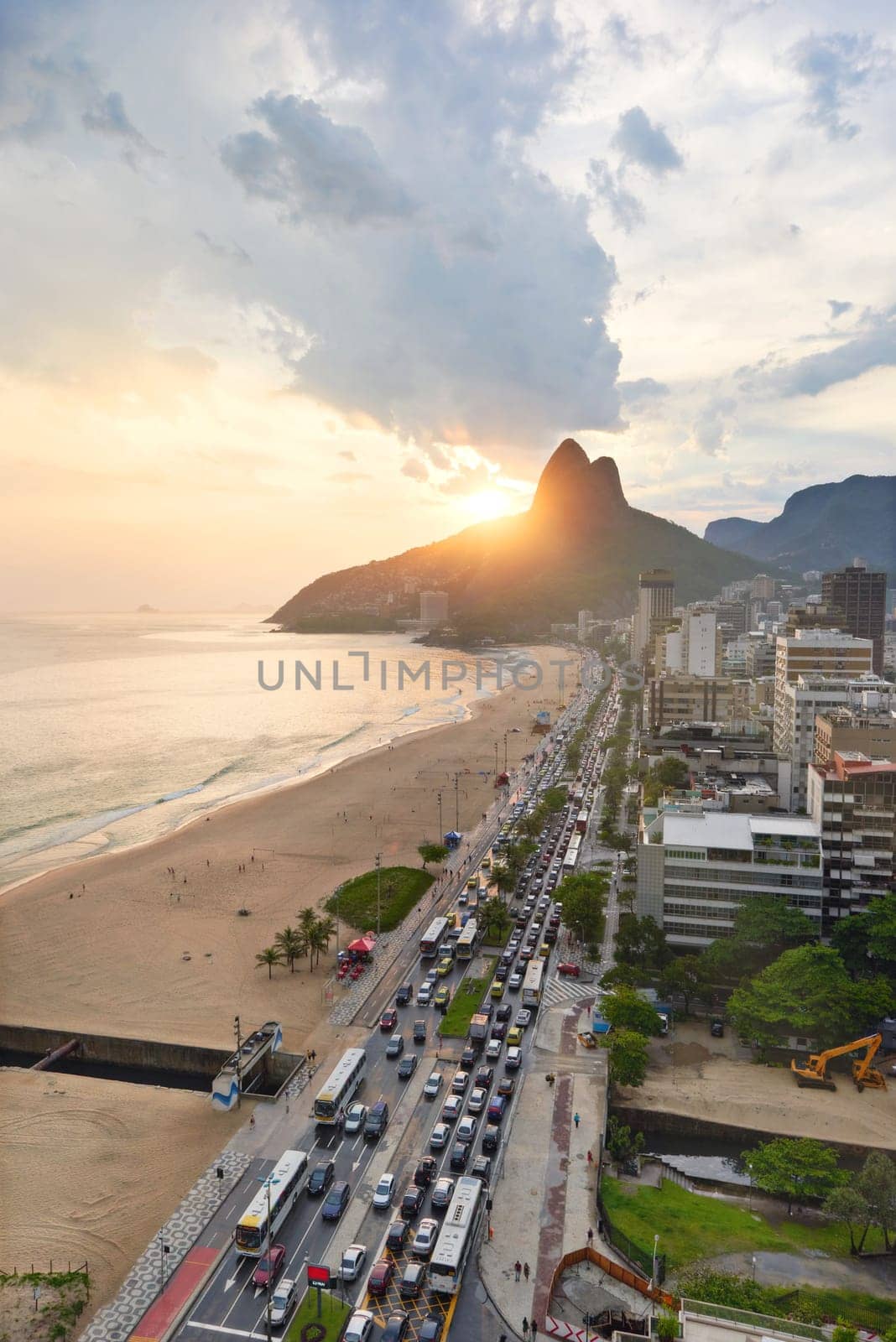 Beach, city and coastal with mountain or building infrastructure or architecture, travel or ocean. Vacation, sand and shoreline in Rio de Janeiro or urban location for Brazil trip, sunset or summer.