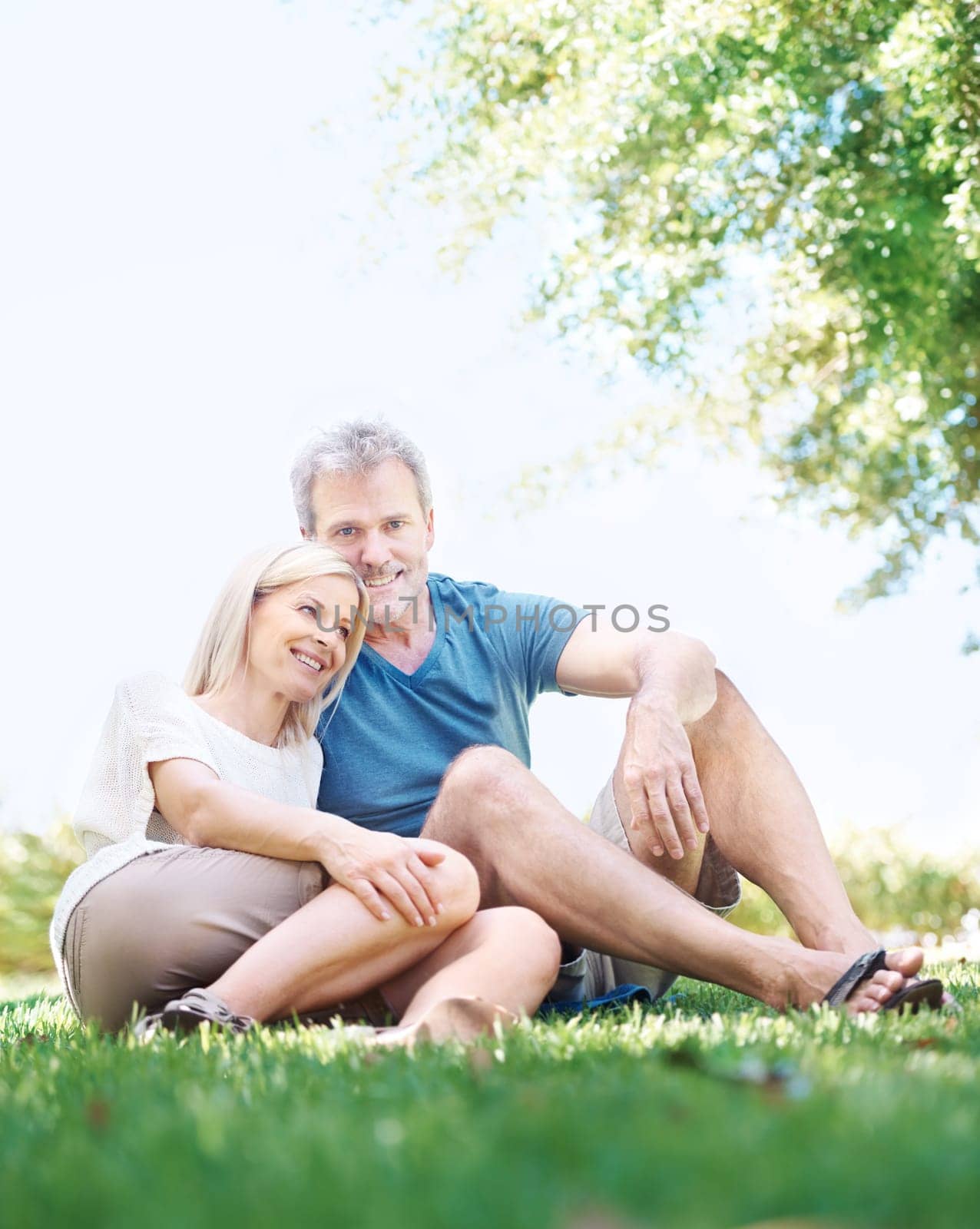 Happy, relax and senior couple in park for bonding, relationship and commitment outdoors on weekend. Portrait, retirement and mature man and woman embrace for romance, love and marriage in nature by YuriArcurs