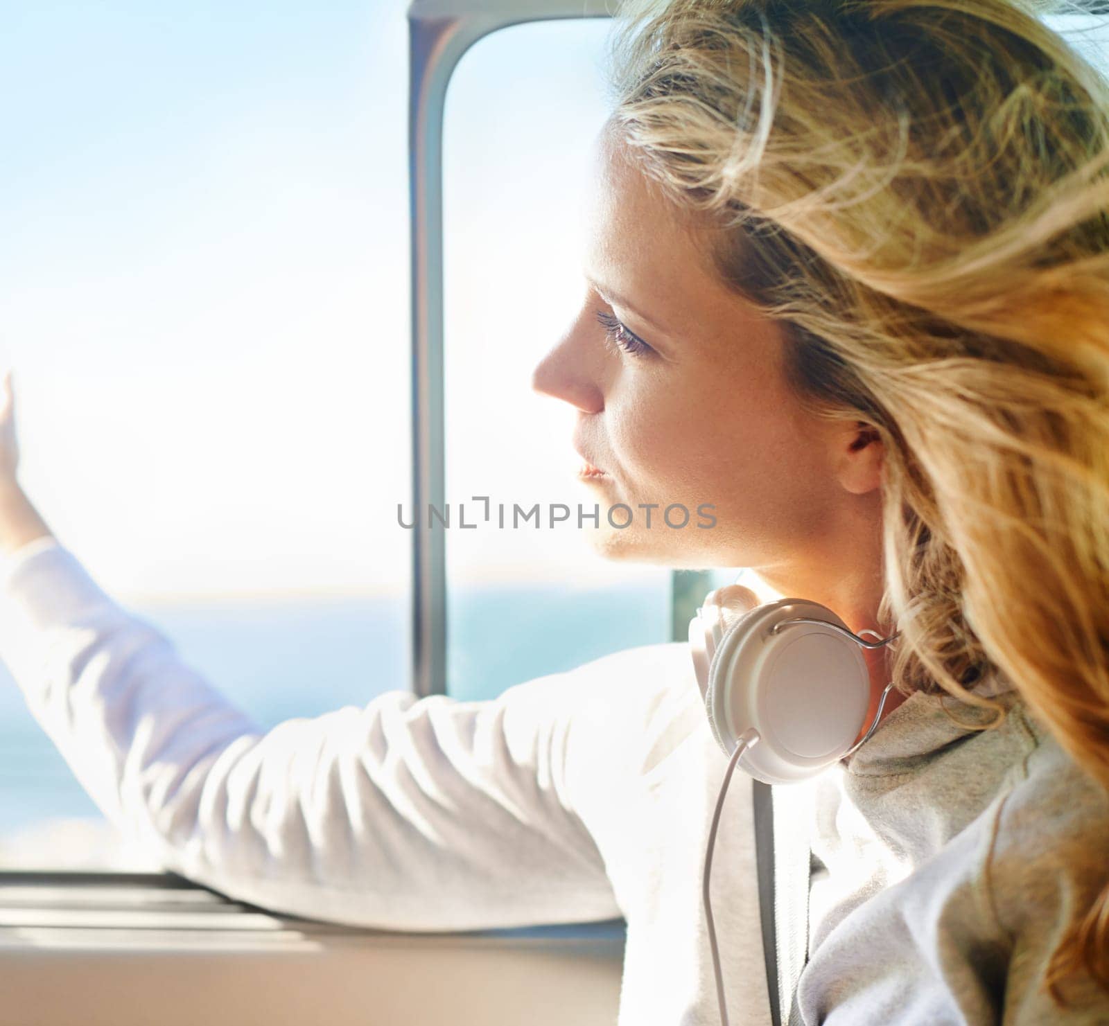 Woman, relax and road trip with headphones on window open for freedom, travel or summer vacation. Female person, calm and thinking on cruise for exploring, weekend journey and transportation.