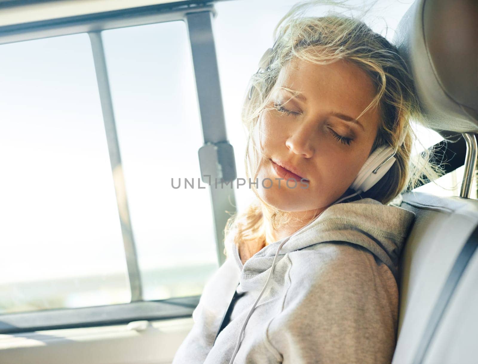 Woman, headphone and car for relax and travel, radio and podcast for calm in transport. Streaming, summer vacation and adventure or road trip, online music and listen or peaceful for journey by YuriArcurs