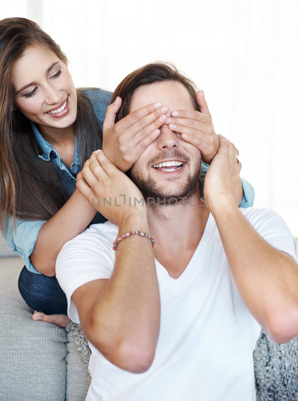 Cover, eyes and couple with happy surprise in home and game with fun reveal or announcement. Guess, who and partner with hands on face to hide secret, news or woman playing prank in marriage.