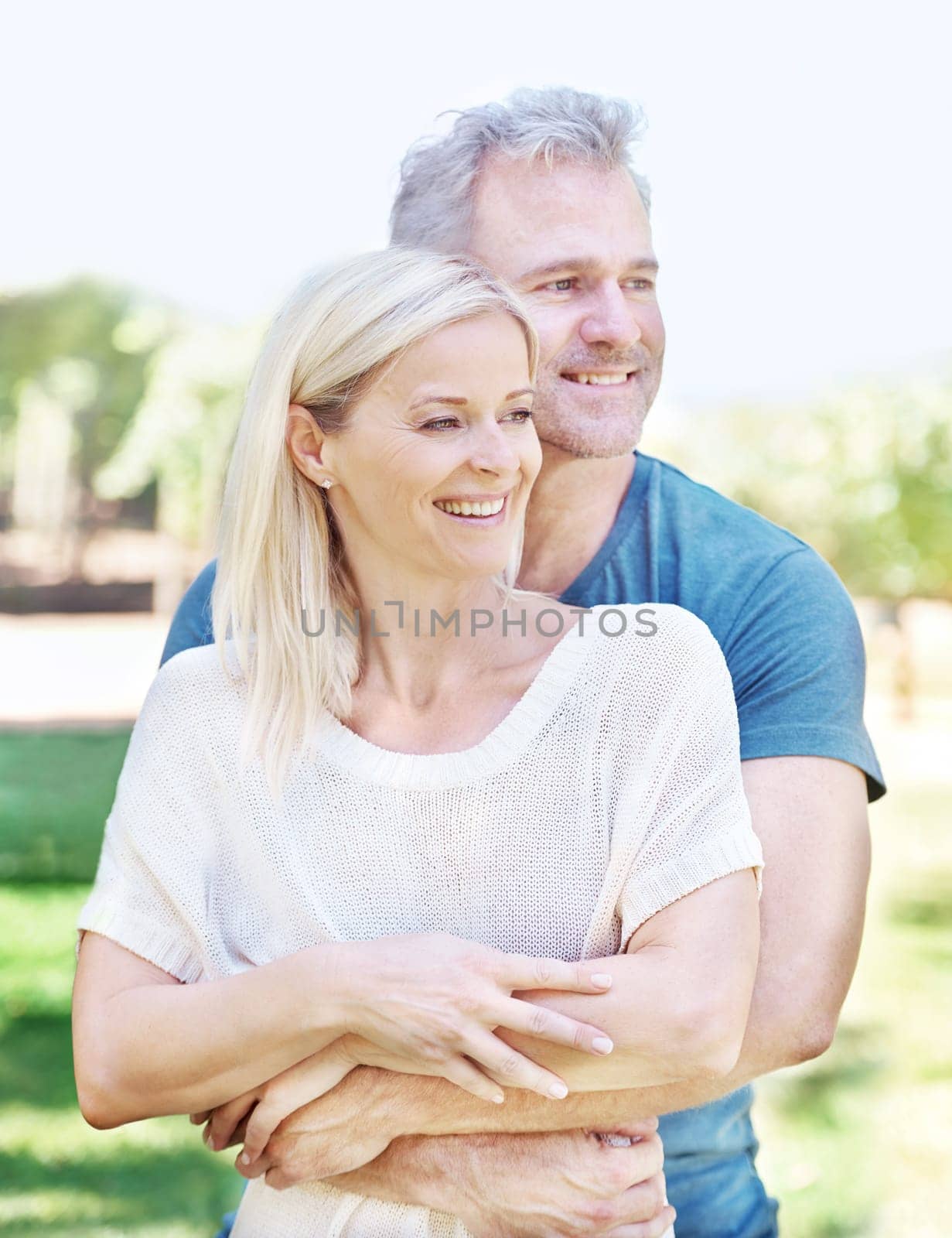 Marriage, hug and senior couple in park for bonding, relationship and commitment outdoors on weekend. Happy, retirement and mature man and woman embrace for romance, relaxing and love in nature by YuriArcurs