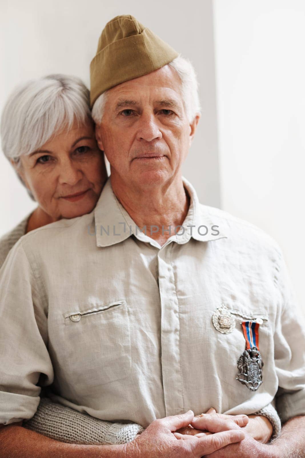 Military, old man and woman with veteran in uniform with medal or pride for memory of battle service. Elderly couple, army or retirement from duty to government with support, care or hug from partner.