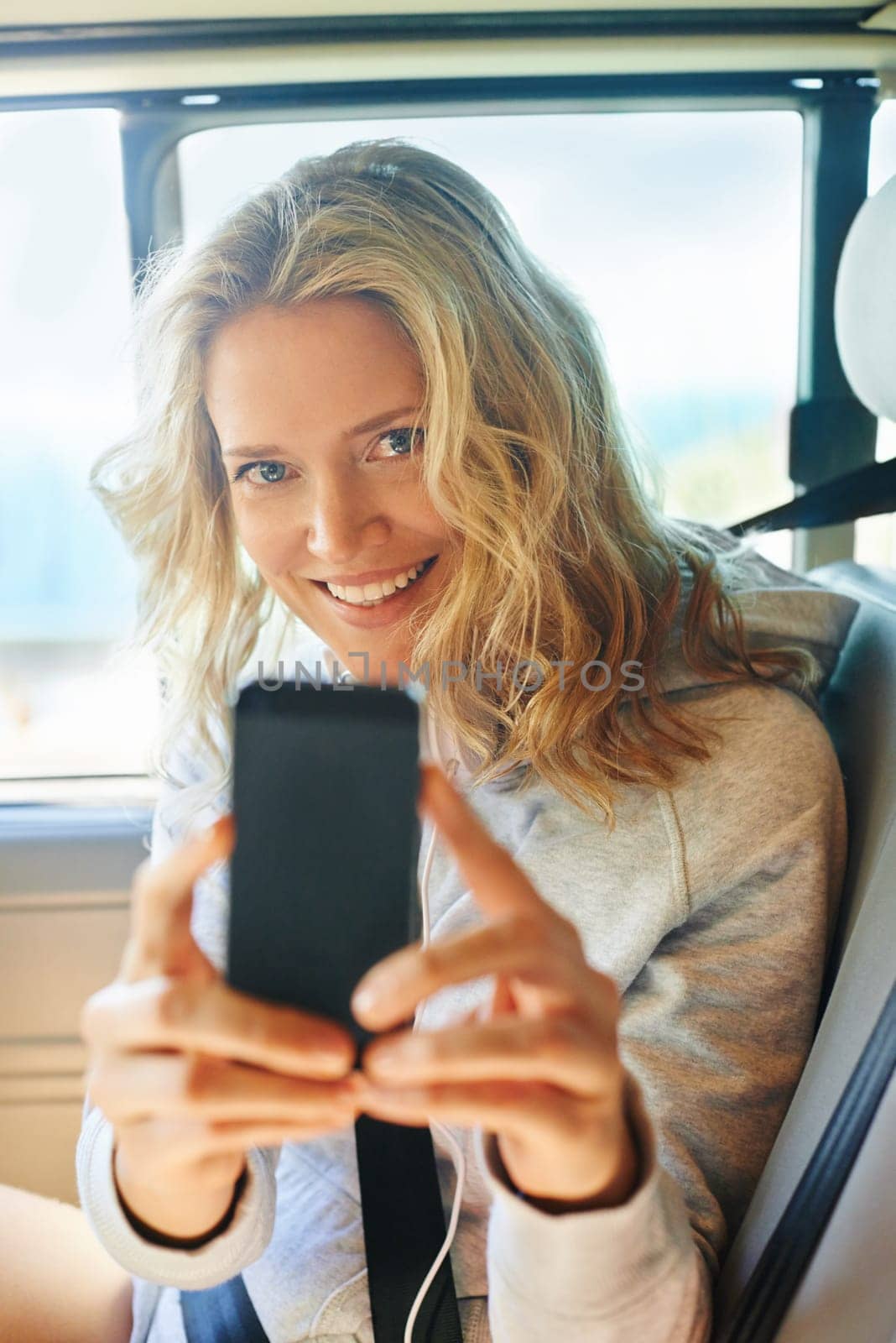 Woman, portrait and phone in car for photo, memory and road trip while on vacation or travel. Female person, smile and smartphone in vehicle for picture, fun and adventure while on holiday in Arizona by YuriArcurs