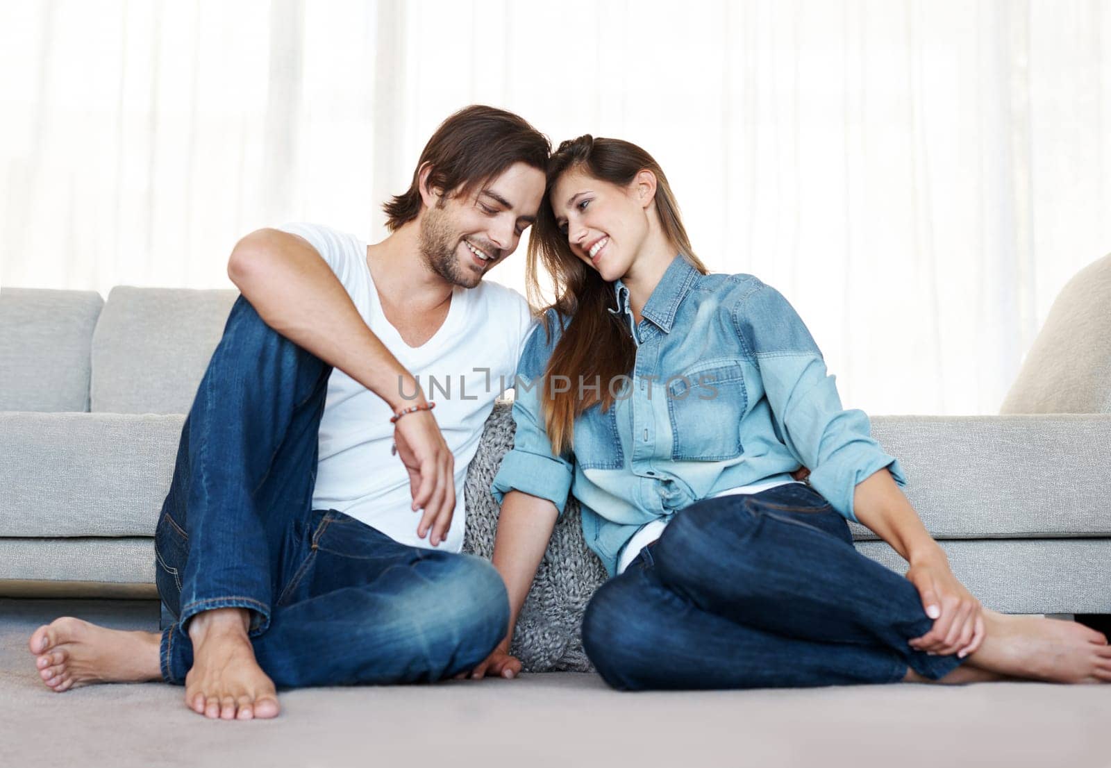 Couple, apartment and relax in new home with love together in marriage with happiness. Smile, man and woman on sofa in house with pride for investment in real estate, property and care for partner by YuriArcurs