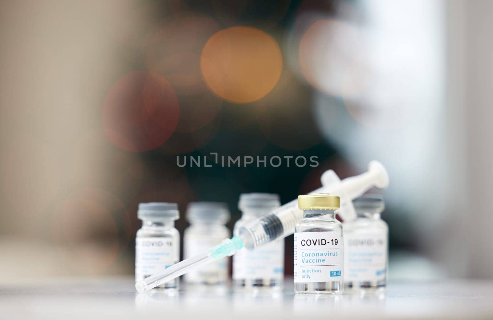 Covid vaccine, syringe and and table for medical, health and wellness for pandemic safety. Medicine, vial and needle for corona, drug and risk control for disease treatment and pharmaceutical product.