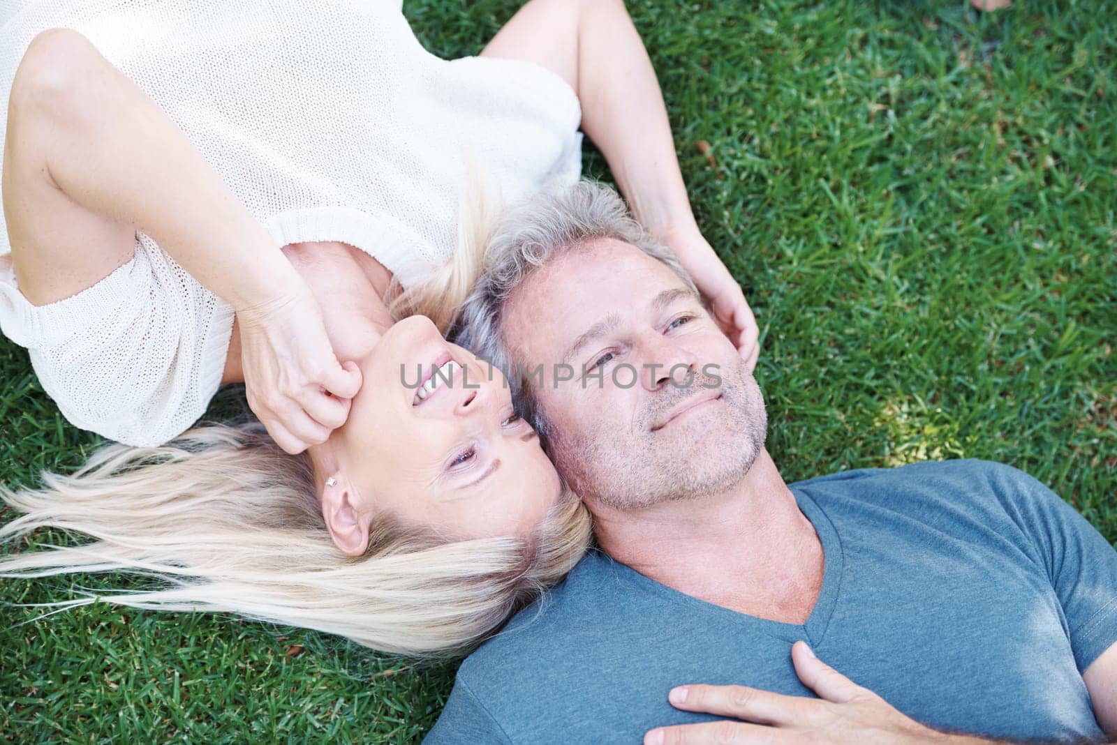 Happy couple, mature and grass or lying relax for relationship date on anniversary, bonding or connection. Man, woman and top view together in New Zealand or garden park for love, resting or summer.