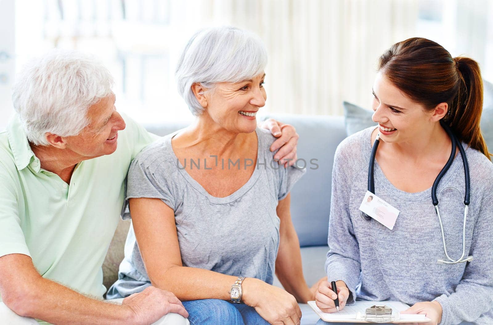 Senior, couple and happy consultation with doctor and results of health or cancer rehabilitation. Patient, report and nurse in elderly care with news, info or medical notes with support and advice by YuriArcurs