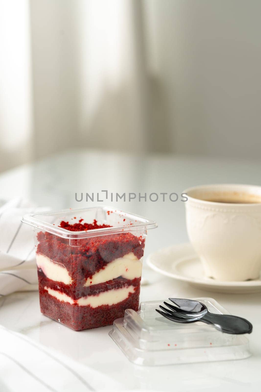 Trifle red velvet in plastic cup on table by Fabrikasimf