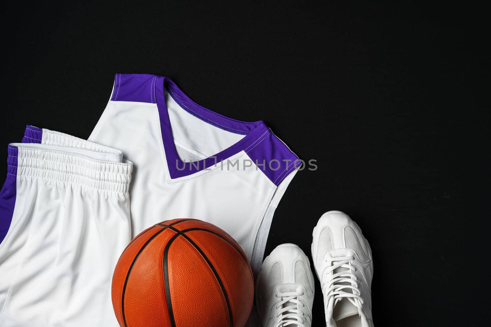 Basketball Outfit and Accessories Laid Out on Dark Background by Fabrikasimf