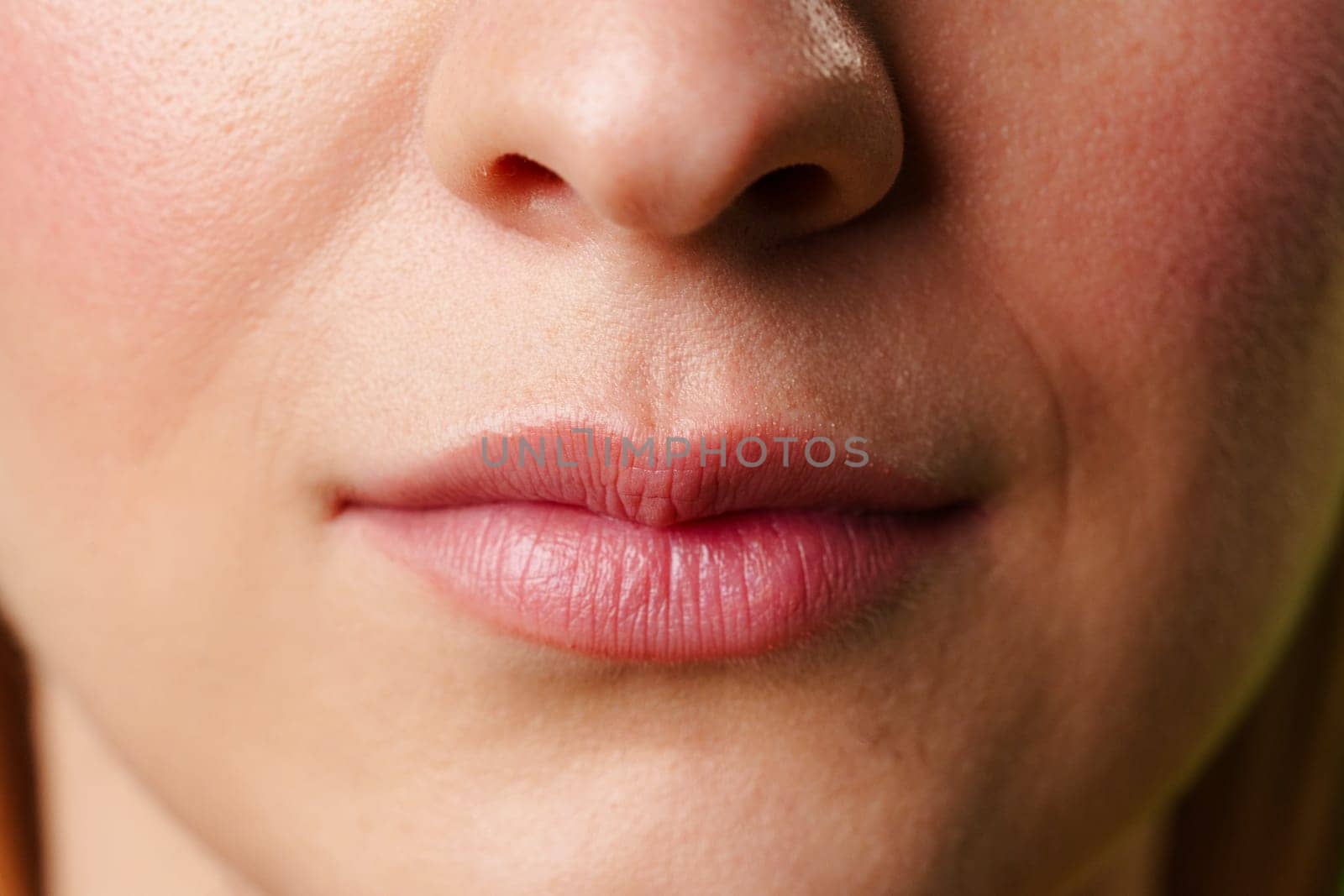 Close-Up of a Womans Lips and Nose With a Neutral Expression by Fabrikasimf