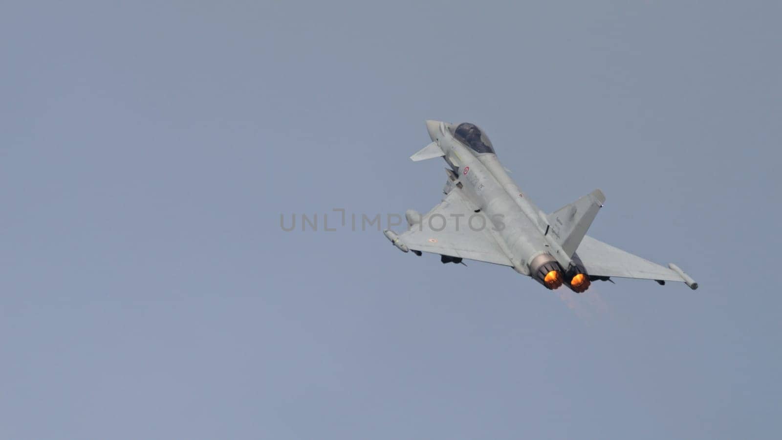 Istrana Italy April 5 2024: Supersonic Fighter Jet Climbs with Full Engine Power to Intercept a Thread. Eurofighter Typhoon of Italian Air Force. Copy Space.