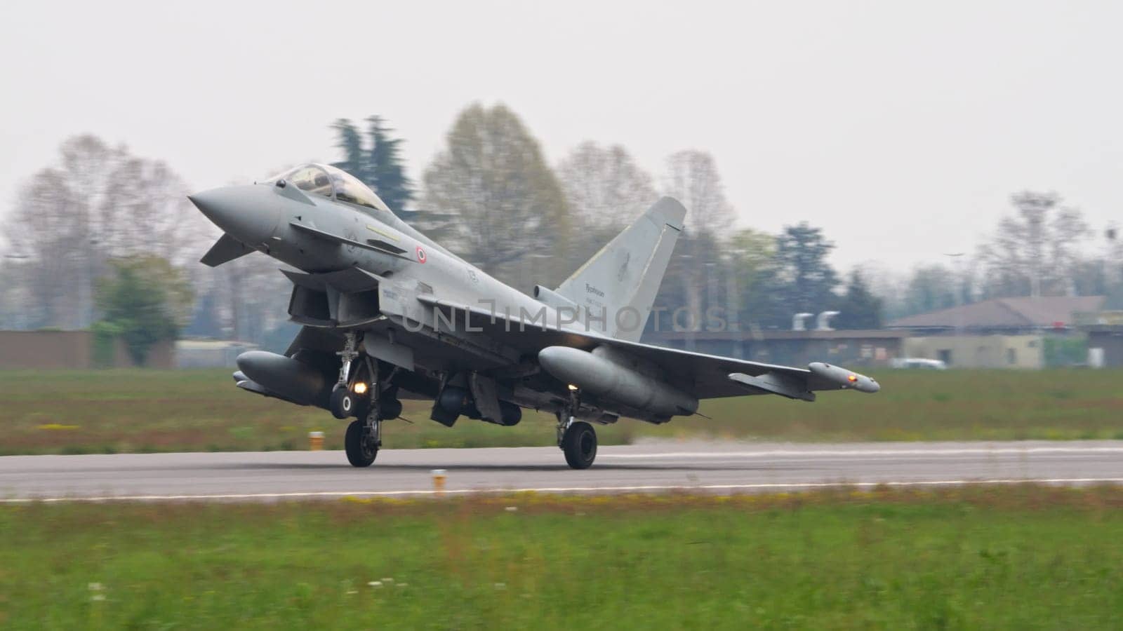 Istrana Italy April 5 2024: Combat Aircraft Landing on a Military NATO Airport with Nose Up to Slow Down. Eurofighter Typhoon of Italian Air Force. Copy Space.