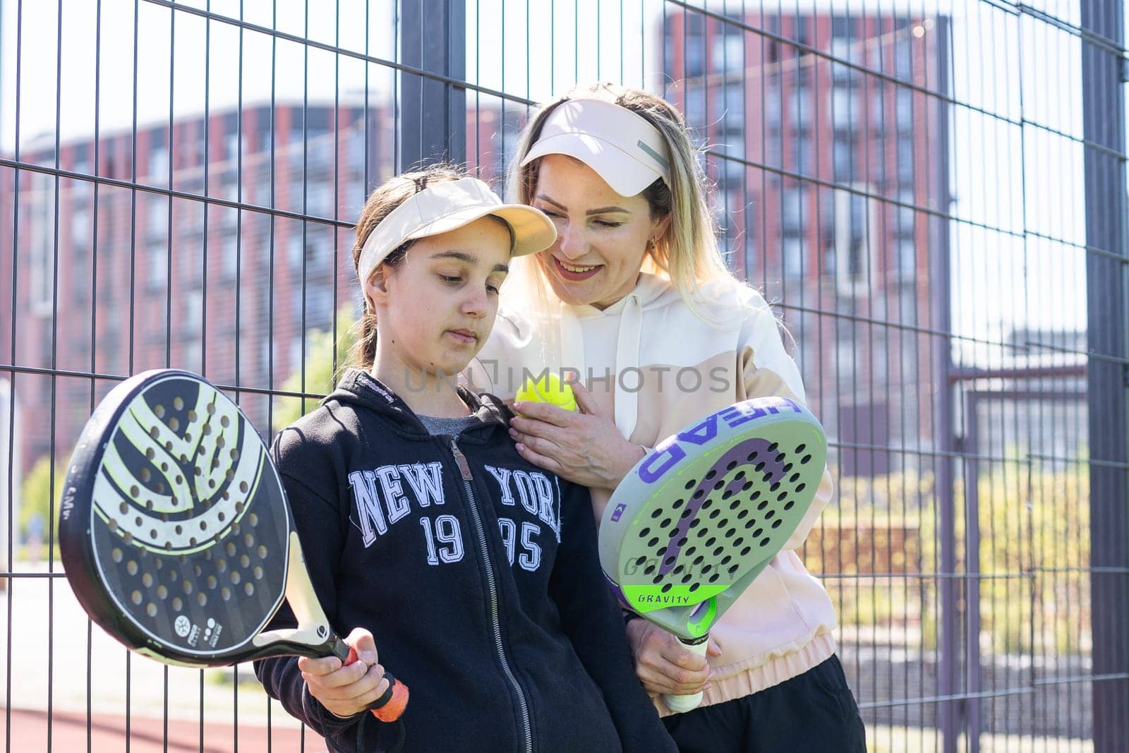 Ukraine Kyiv, April 20 2024. Portrait of smiling woman paddle tennis player during couple match at court. High quality photo