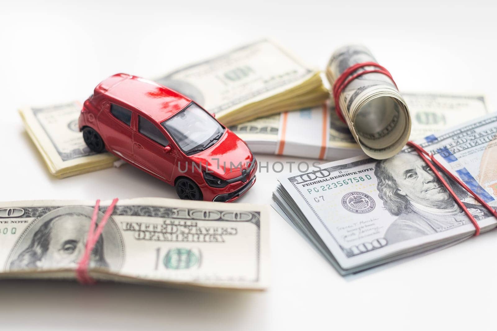 Small decorative car model, a lot of cash dollars of USA, credit for car concept. High quality photo