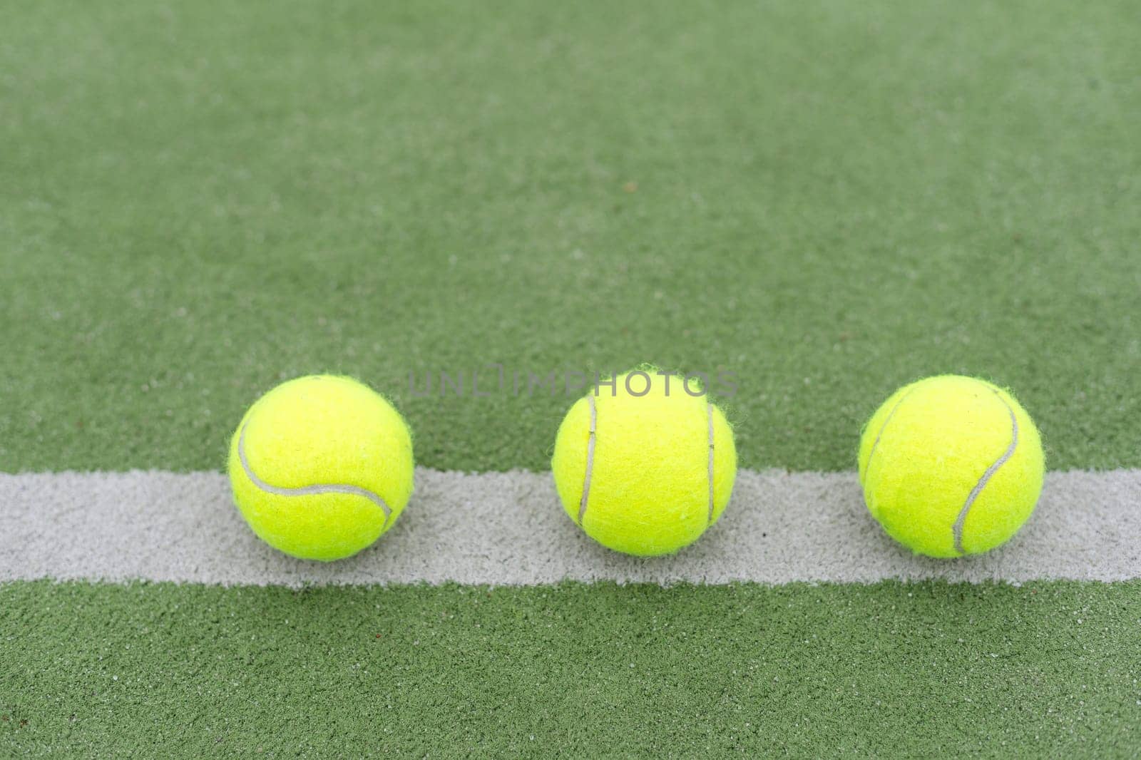 close up of a padel and tennis court with artificial grass and balls. High quality photo