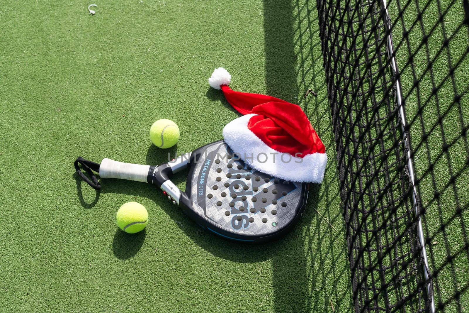 Ukraine Kyiv, April 02 2024. Christmas Open Padel Tournament. Poster for social networks for New Year's games. Padel tennis racket on tournament. paddle racket on court . High quality photo