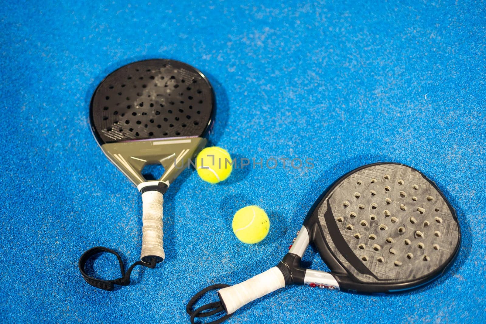 rackets paddle with two balls on blue background. High quality photo