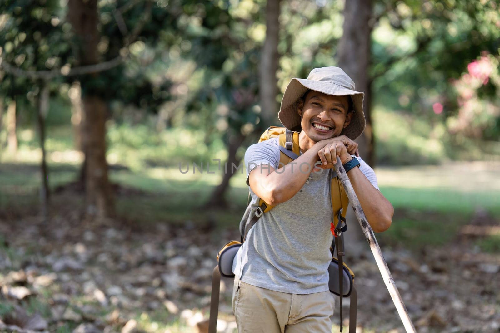 man with backpack walk along forest path while hiking and camping on the weekend by itchaznong