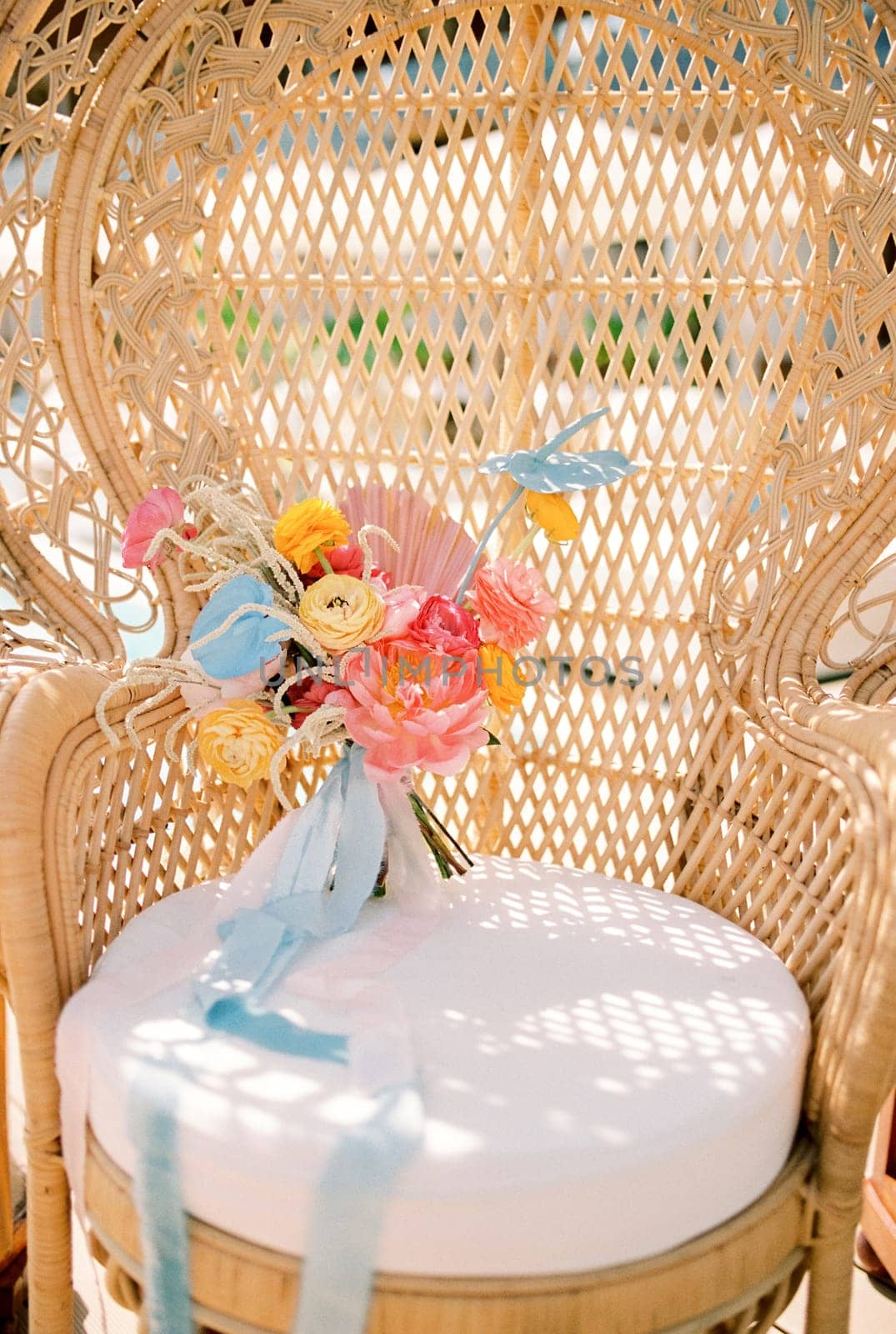 Colorful bridal bouquet stands on a wicker armchair. High quality photo