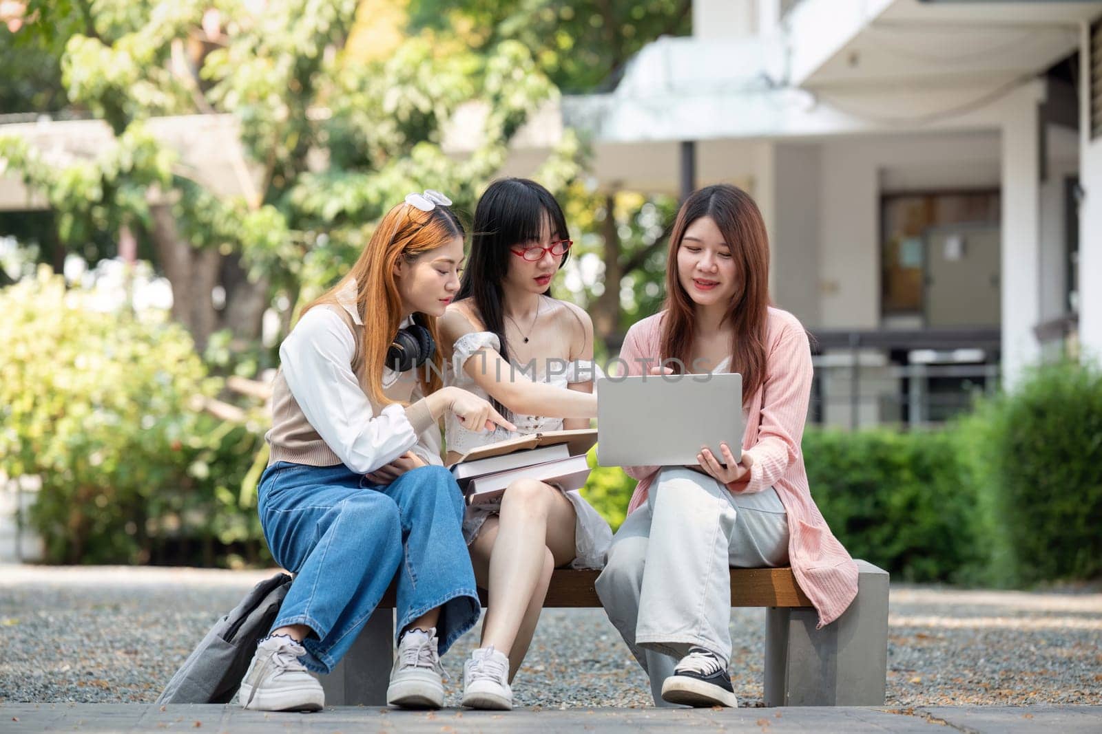 Asian young campus student enjoy learn study and reading books together. Friendship and Education concept. Campus school and university. Happiness and funny of learning in college.