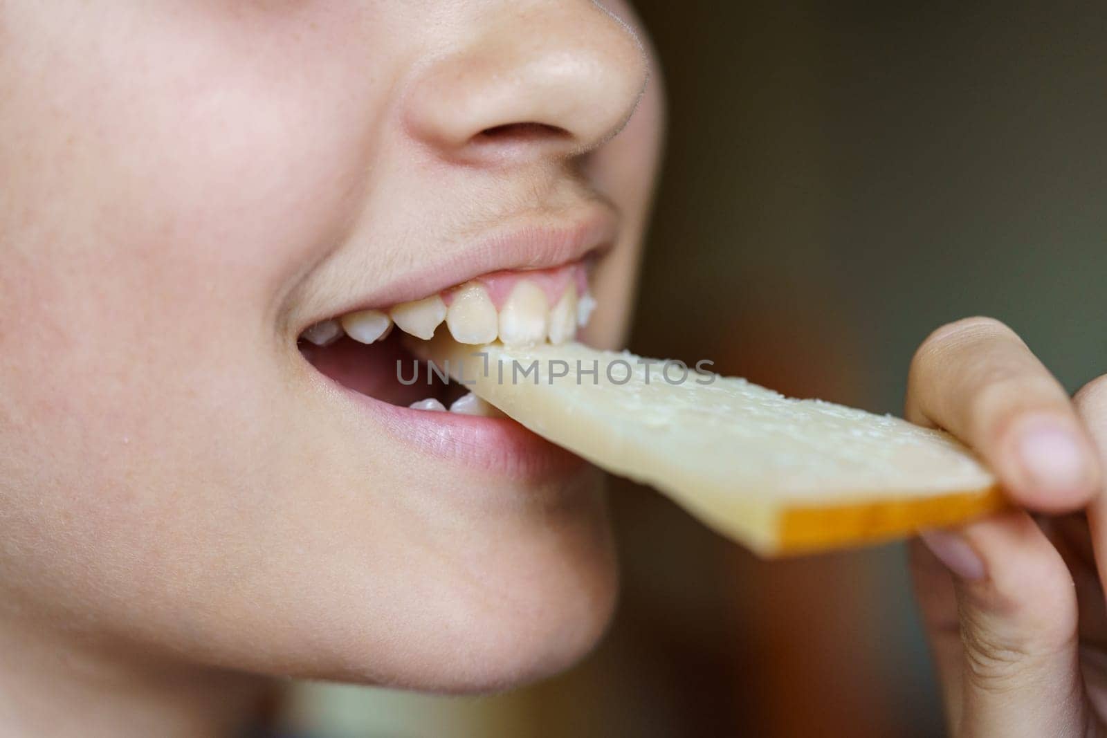 Happy anonymous teenage girl eating fresh cheese slice by javiindy