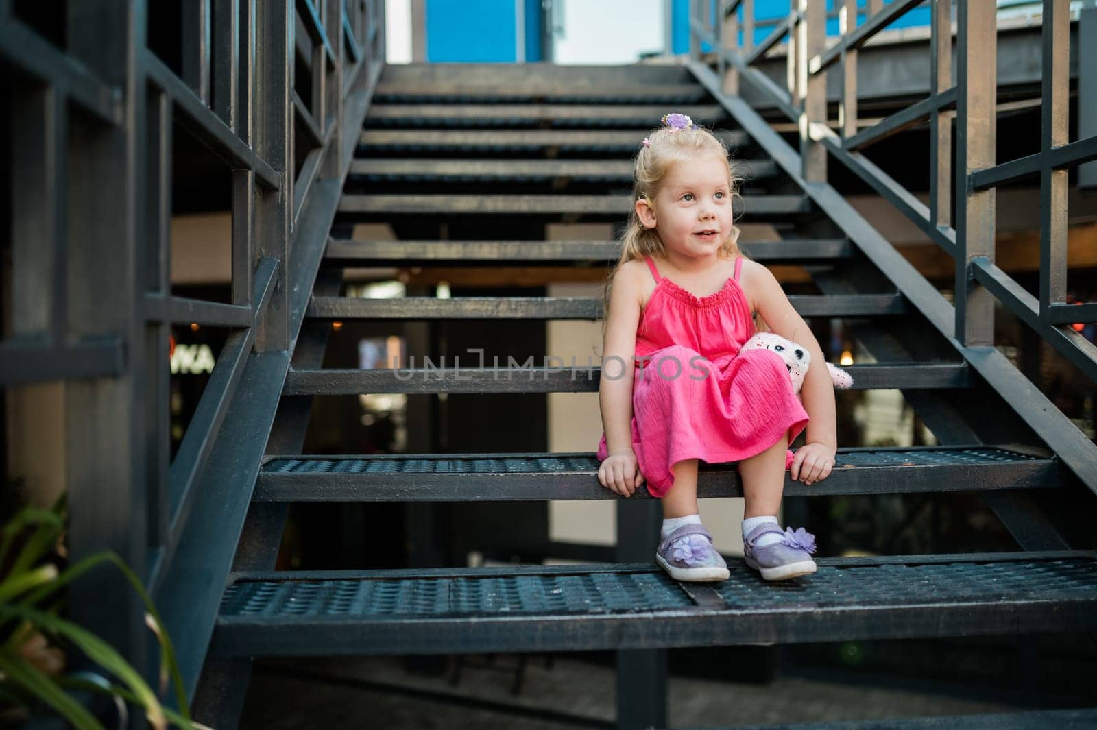 Funny baby with cochlear implant walks outdoor. Hearing aid and medicine innovating technology concept. Diversity and inclusion. Copy space.