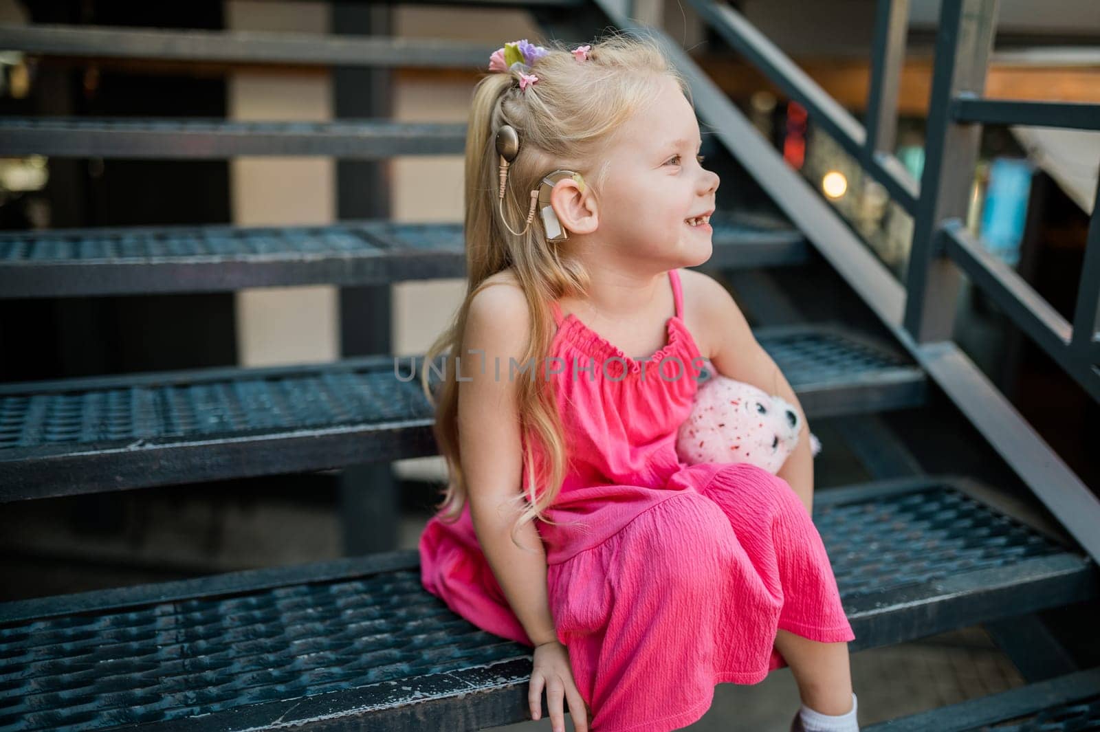 Child head with cochlear implant hearing aid. Hearing aid and medicine innovating technology and diversity concept