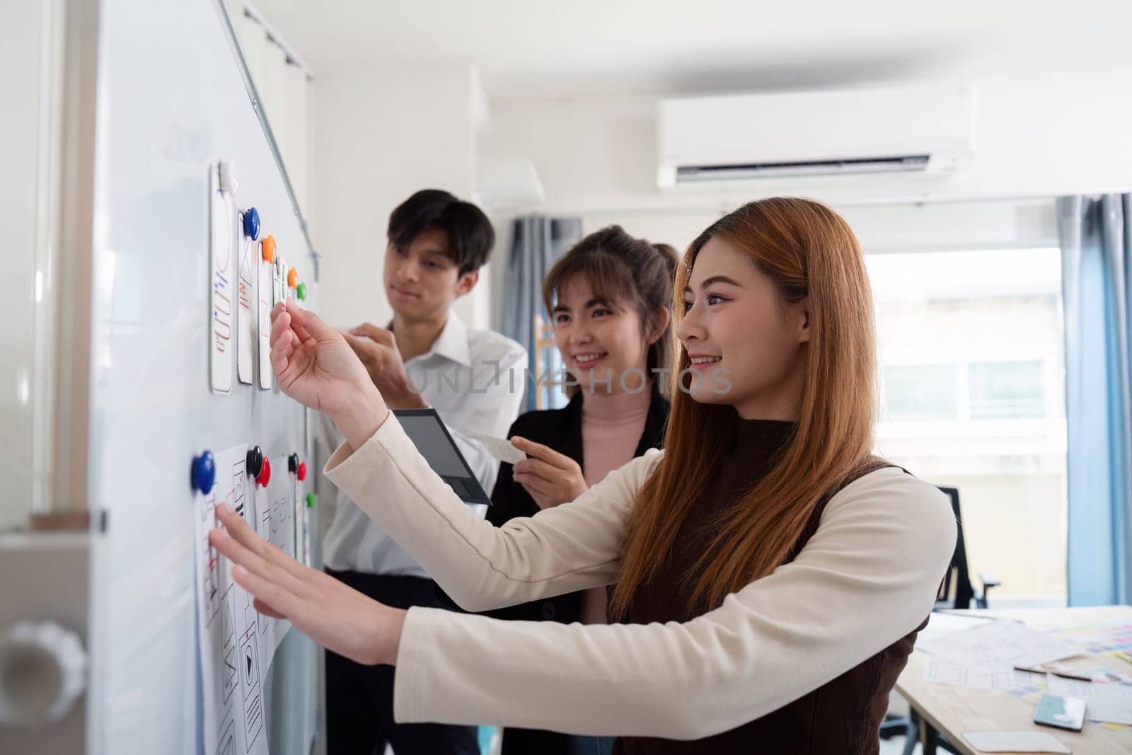 Team of creative ux developer and ui designer brainstorm about app interface design at modern office. Creative digital development.