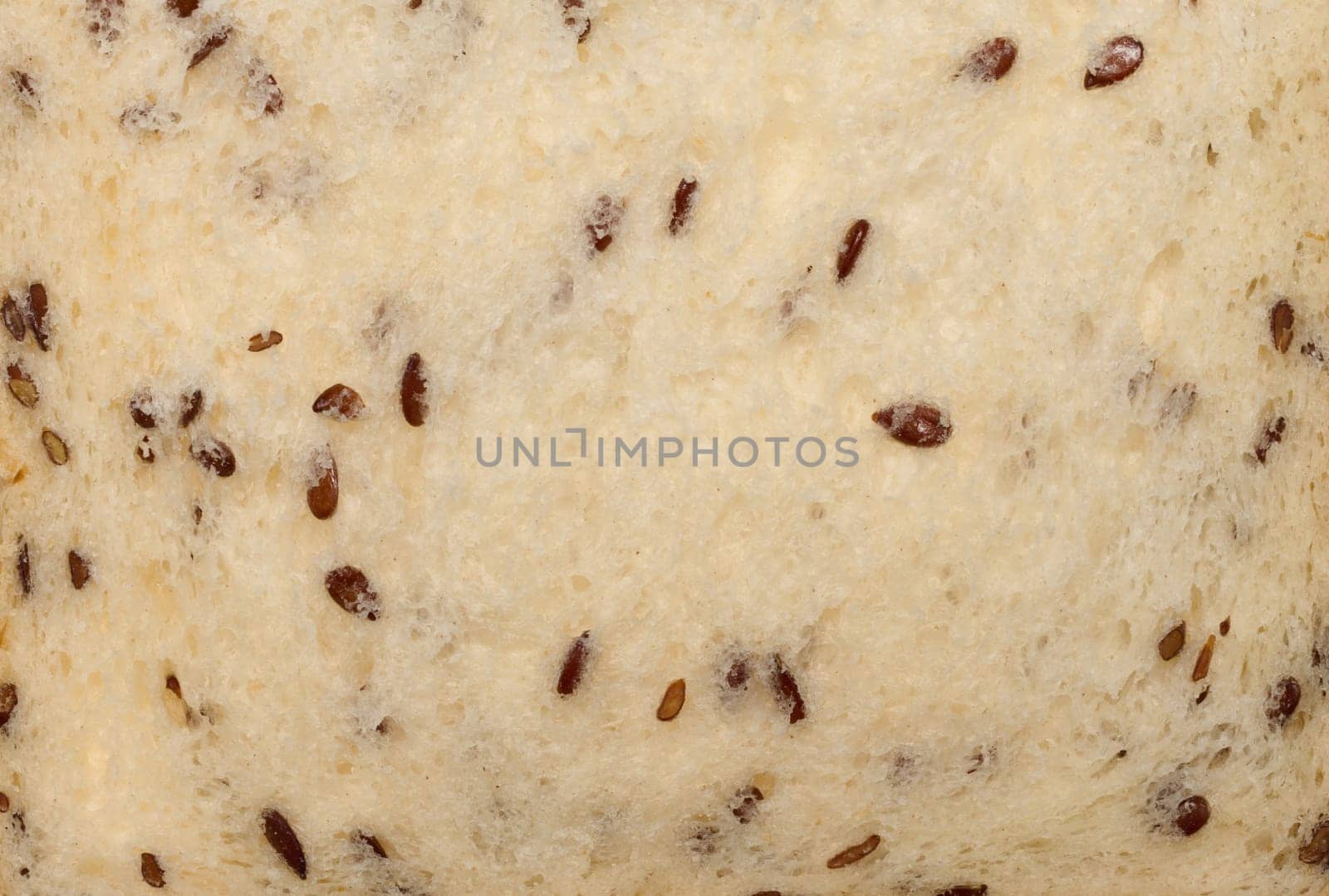 Piece of wheat flour bread with flax seeds, close up