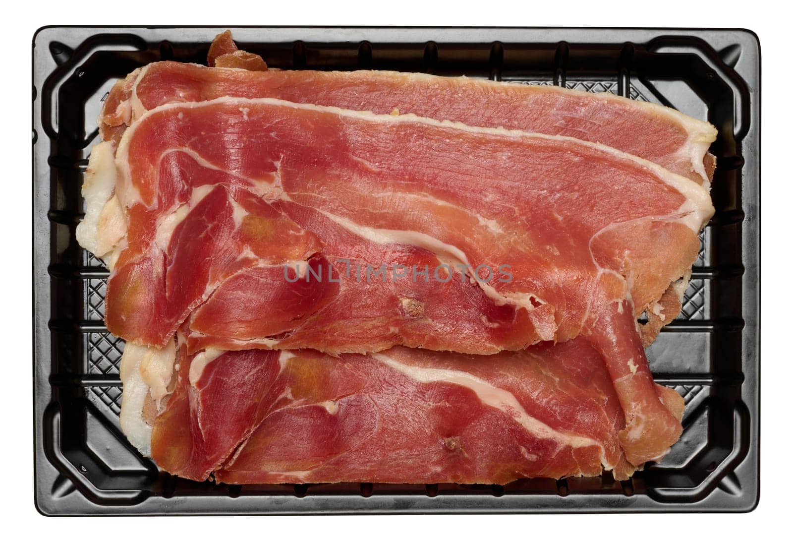 Thinly sliced jamon in a plastic container on an isolated background, top view