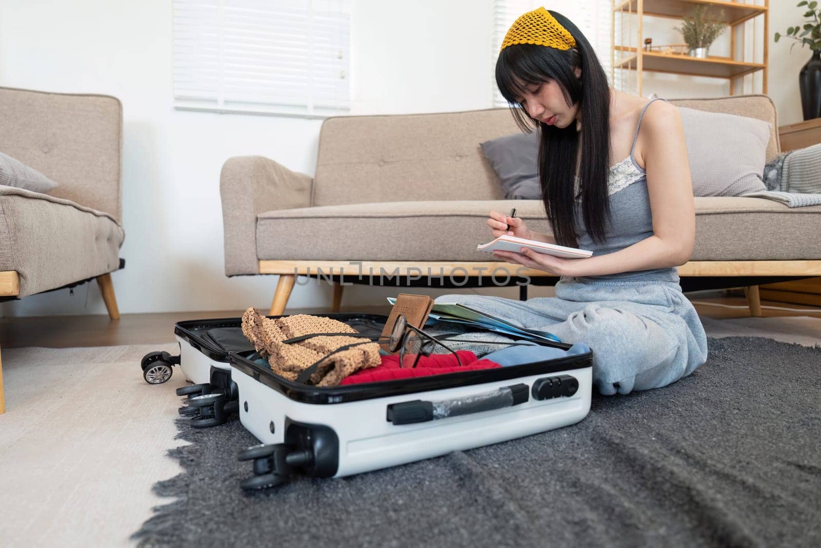 Woman and suitcase for travel summertime vacation packing clothing. relax and getaway preparation by nateemee