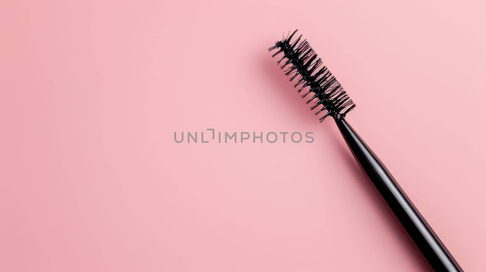 Close up of black brush on pink background.
