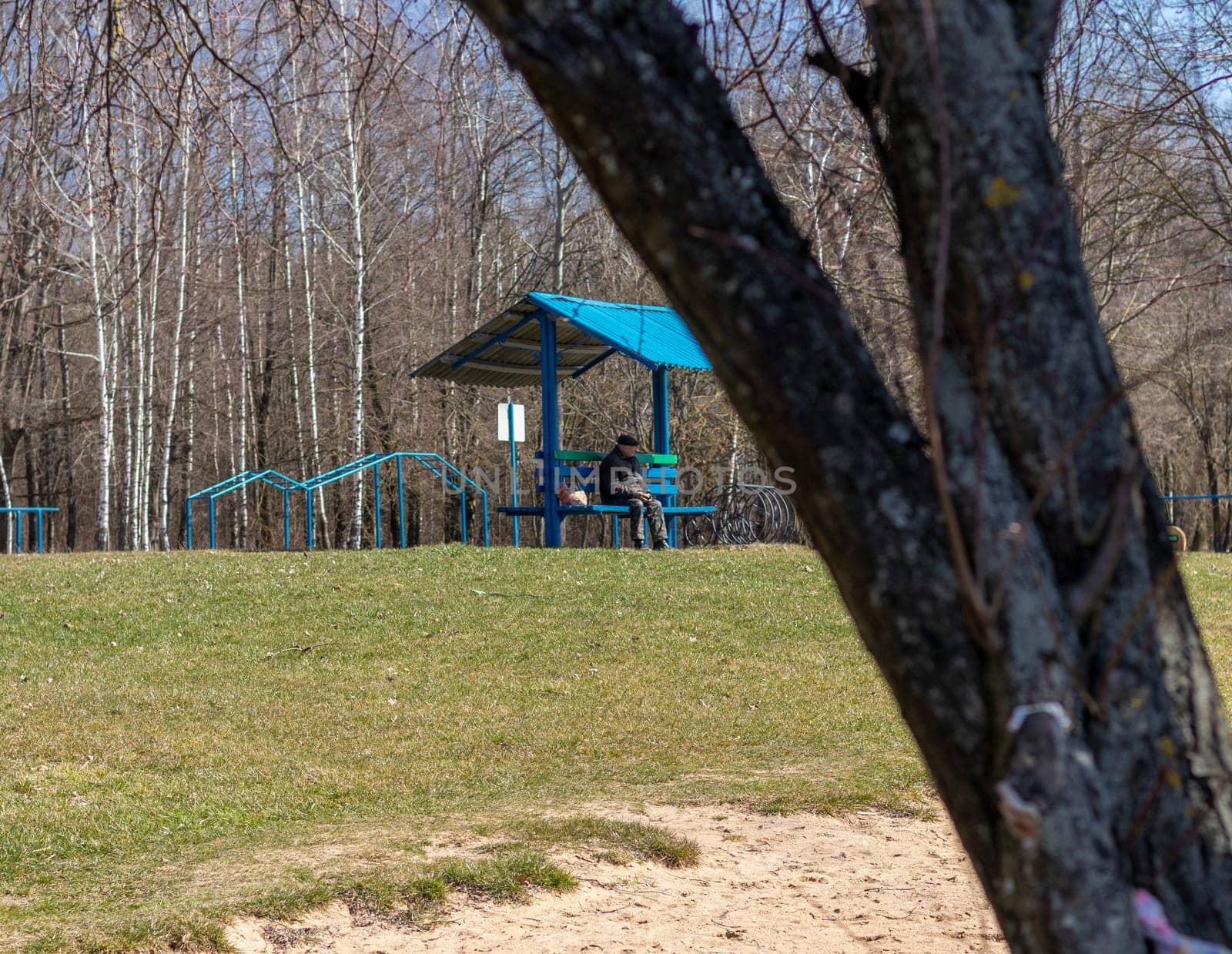 Minsk, Belarus - 03.03.2024 - Senior citizen enjoying sunny day out in the park