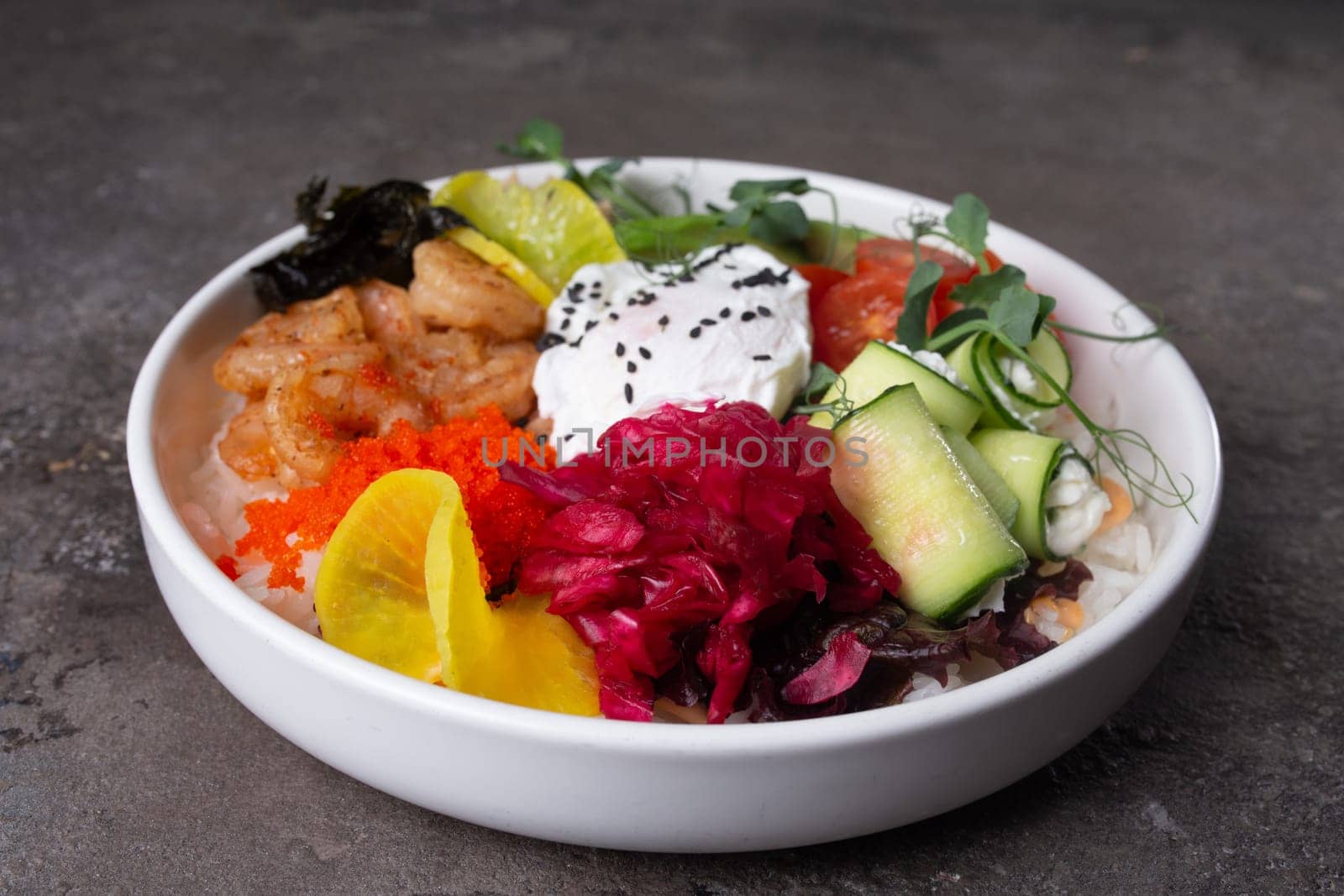 Scrumptious seafood rice bowl with fresh vegetables and egg on a dark background by Pukhovskiy