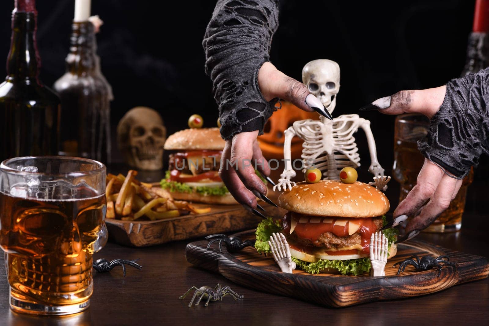 The witches hands want to grab the Monster Burger on the sitting skeleton. Perfect Halloween Party appetizer