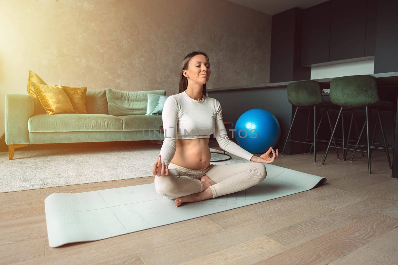 Happy young pregnant woman deep breath with fresh air doing yoga in lotus pose at home, pregnancy with yoga and meditation for healthy life, motherhood and healthy pregnancy concept. High quality photo