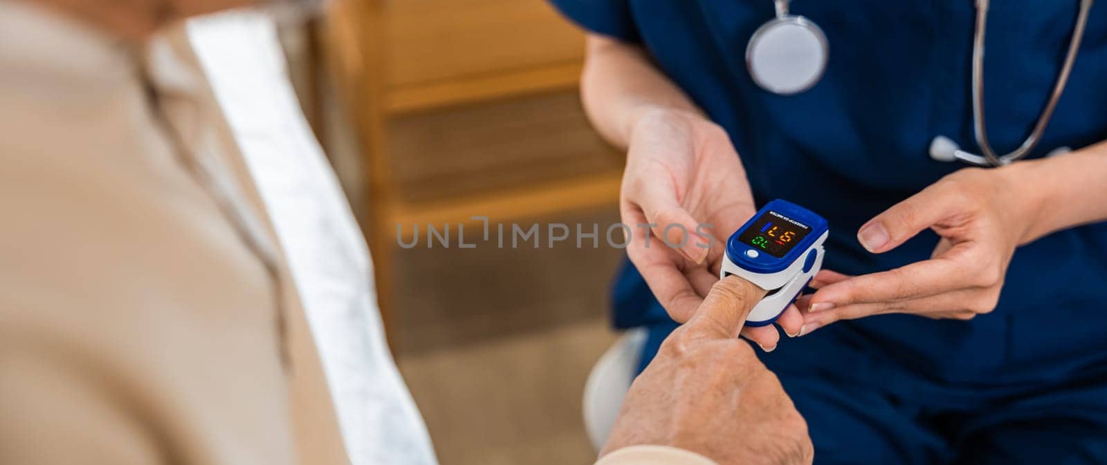 Young woman putting digital oximeter of finger middle aged adult patient for measurement, nurse checking with fingertip pulse oximeter oxygen meter blood monitor finger of senior old man at hospital