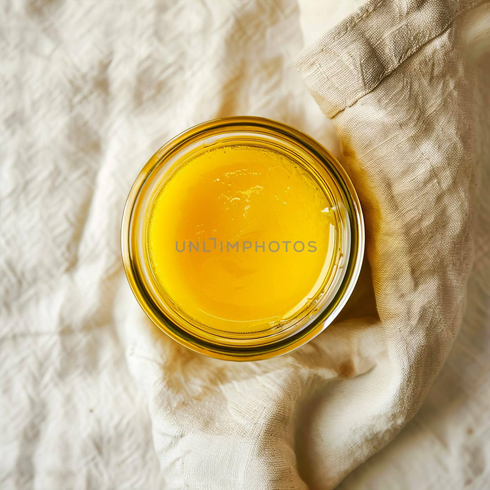 Top view of a jar of ghee on a light background. by OlgaGubskaya