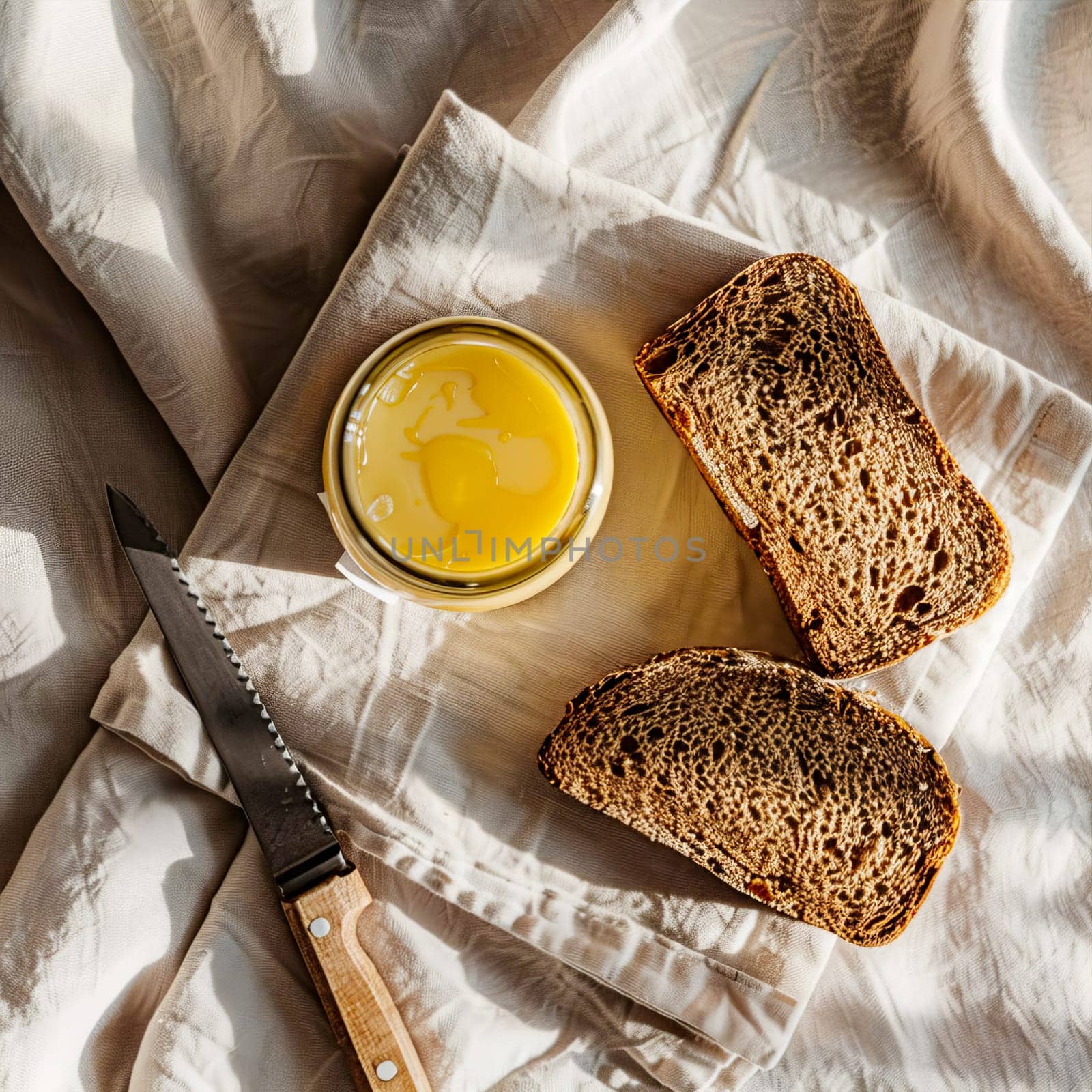 Top view of a jar of ghee and two slices of bread. by OlgaGubskaya