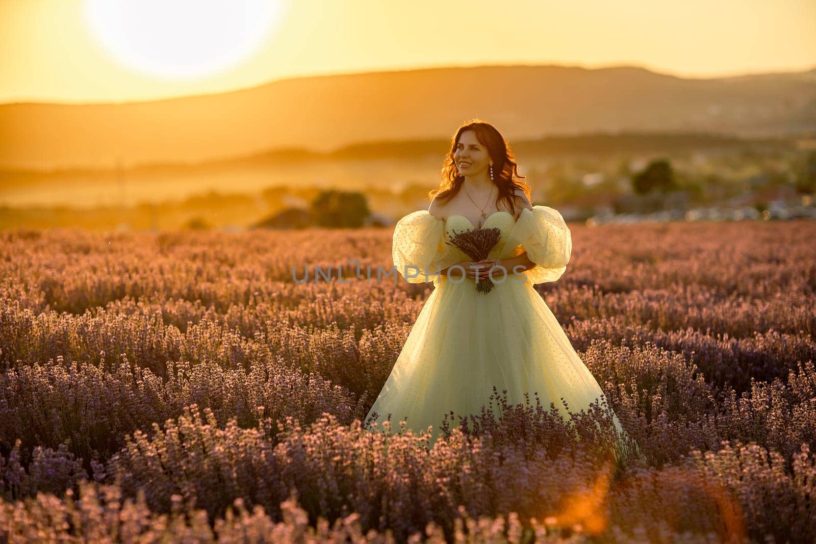 Woman lavender field. happy woman in yellow dress in lavender field summer time at sunset. Aromatherapy concept, lavender oil, photo session in lavender.