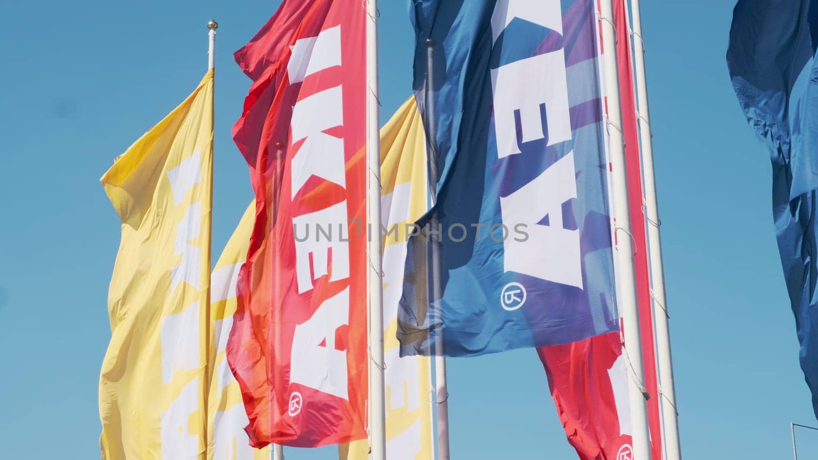PRAGUE, CZECHIA -APRIL, 2024: Colorful IKEA flags waving the wind against sky.