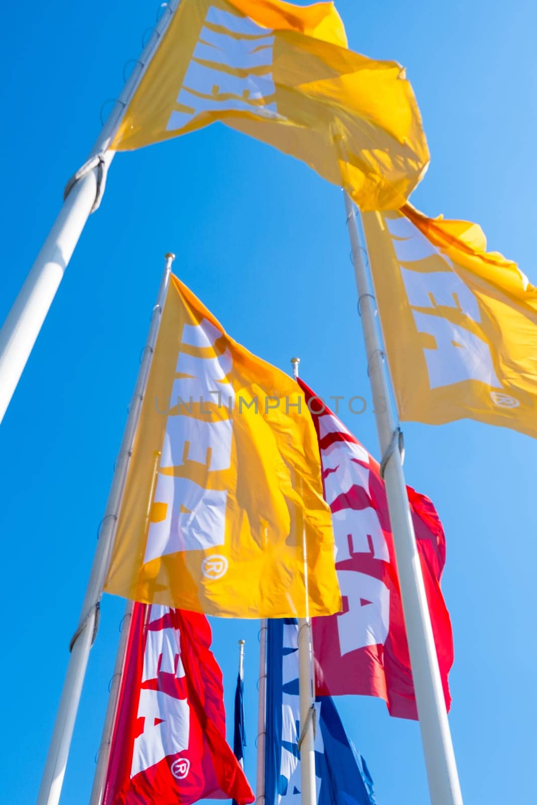 IKEA flags yellow, red and blue with sky on the background by vladimka