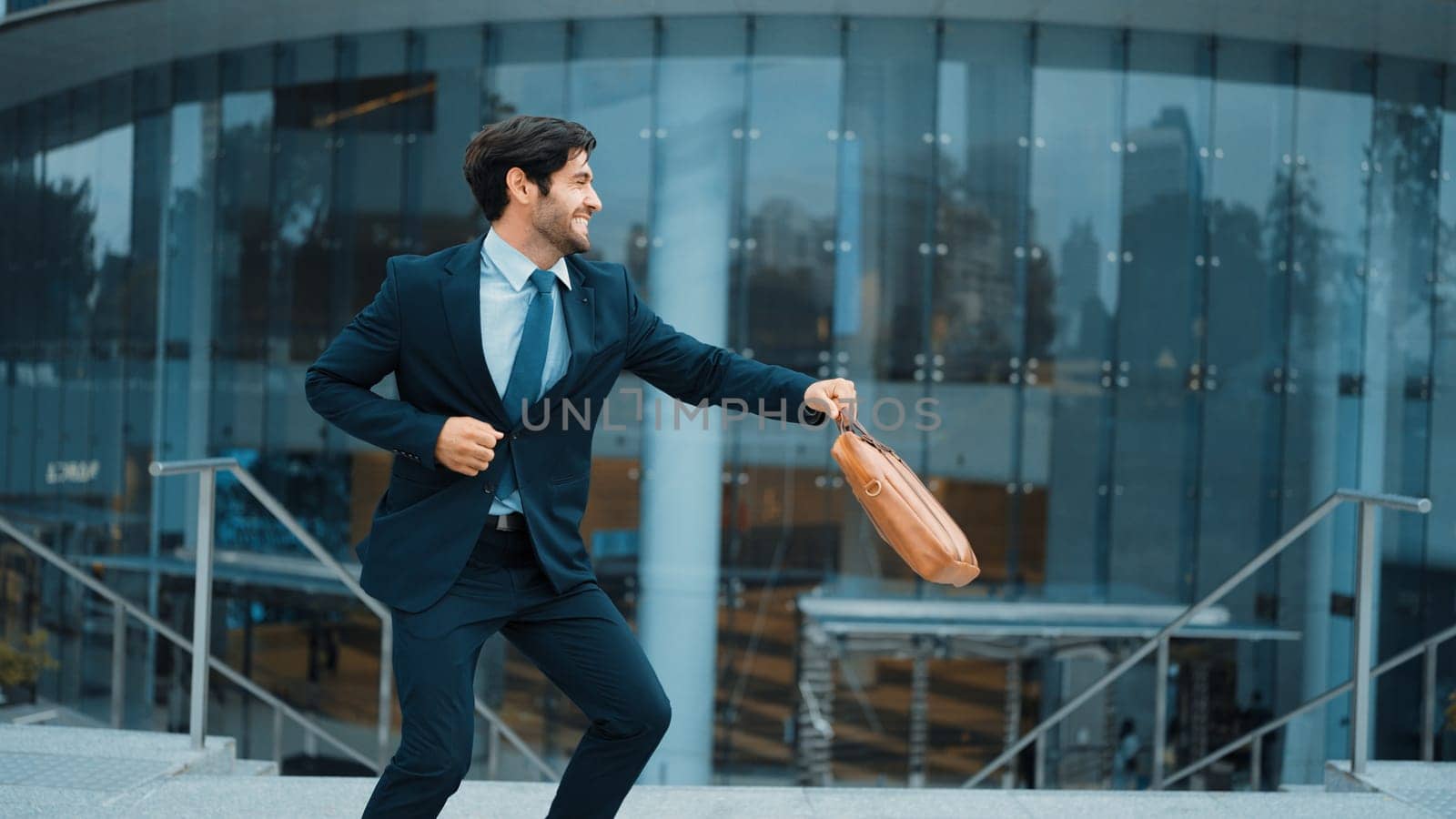 Successful business man celebrate for getting promotion while walking to office. Caucasian receive good news about sales increase or successful project. Manager feel overjoy and happy. Exultant.