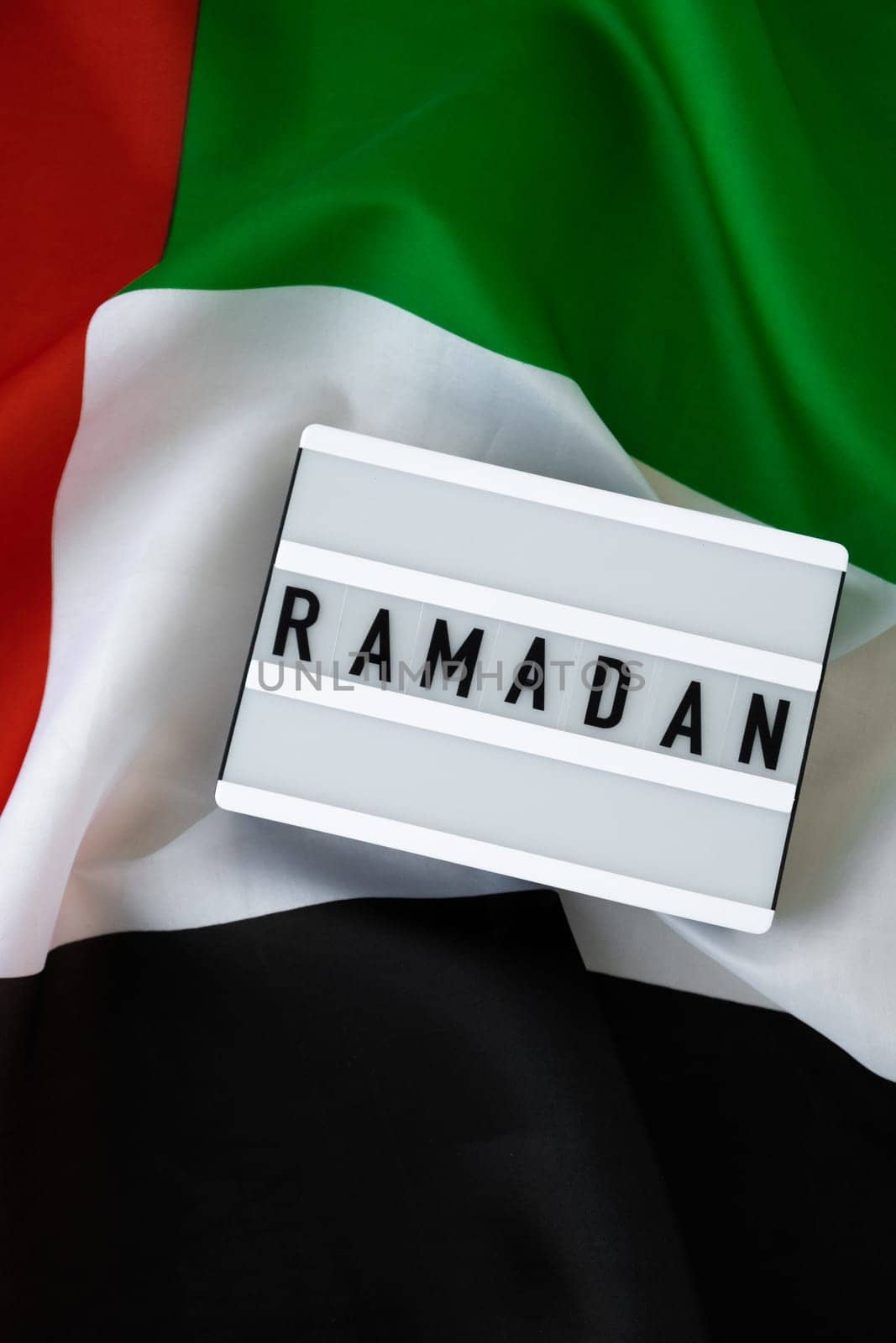 Congratulations Lightbox with text RAMADAN waving UAE flag on background concept. Greeting card advertisement. Commemoration Day Muslim Blessed holy month holiday by anna_stasiia
