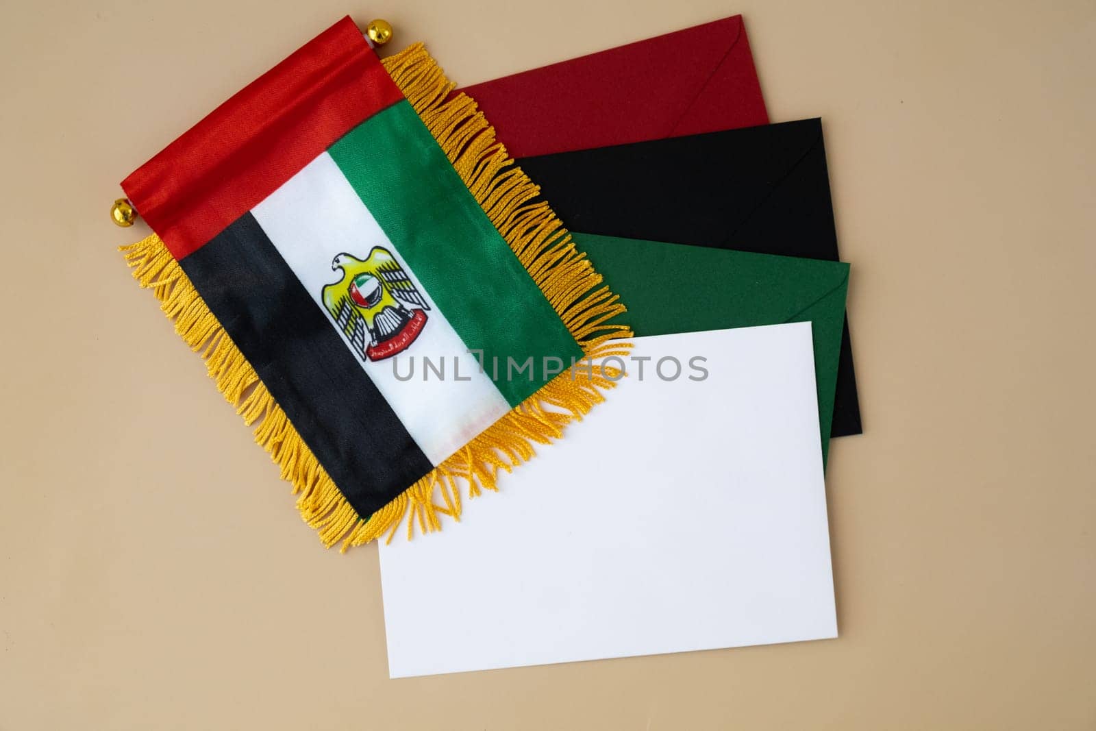 Colorful envelopes template sample National symbol of UAE. United Arab Emirates small flag with Peregrine falcon on neutral beige background. Copy space for your text. Concept of National day Independence