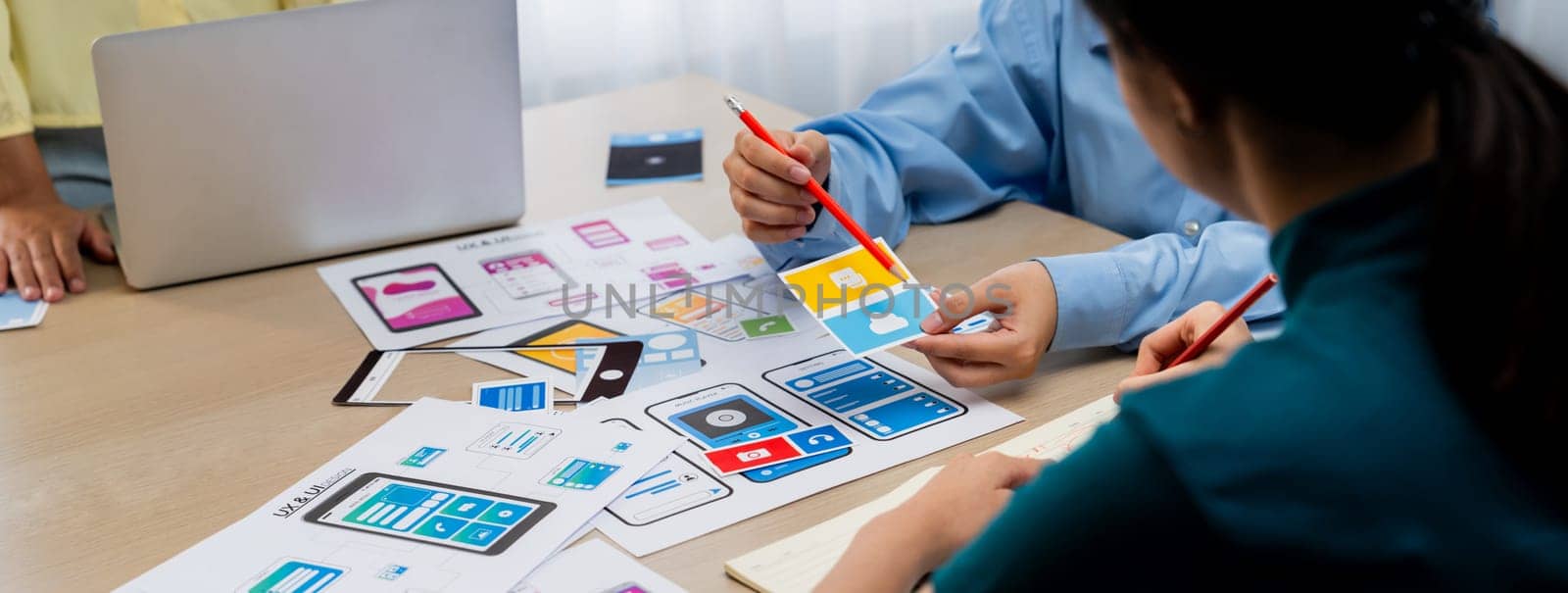 Panorama banner of startup company employee planning on user interface prototype for mobile application or website in office. UX UI designer brainstorm user friendly interface plan. Synergic