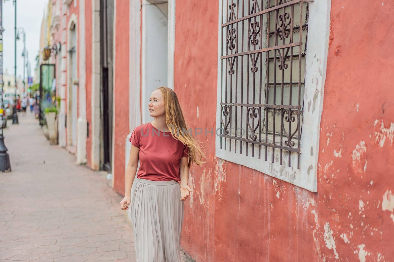 Woman tourist explores the vibrant streets of Valladolid, Mexico, immersing herself in the rich culture and colorful architecture of this charming colonial town.